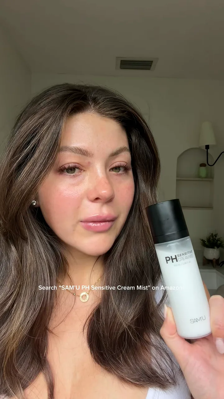 Creator holding a face mist bottle beside her face