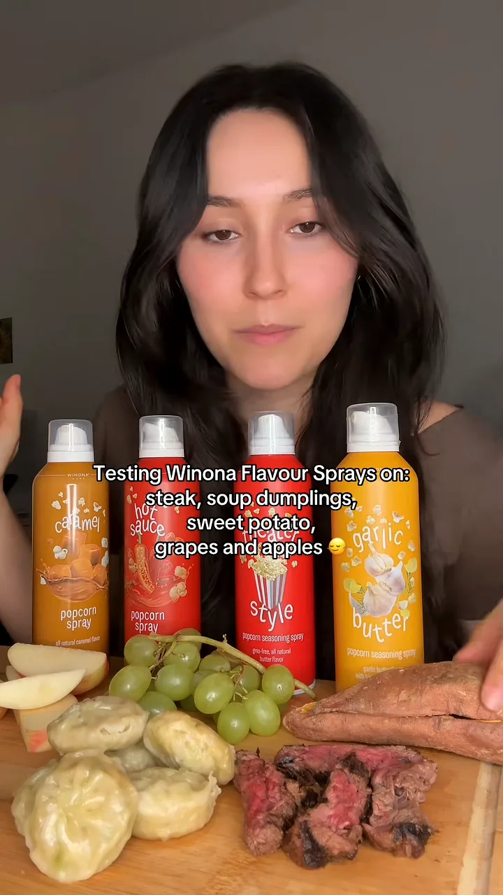 Creator behind four Winona popcorn spray cans and a board of steak, dumplings, grapes and sweet potato