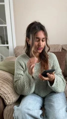 Creator on a sofa looking at her phone