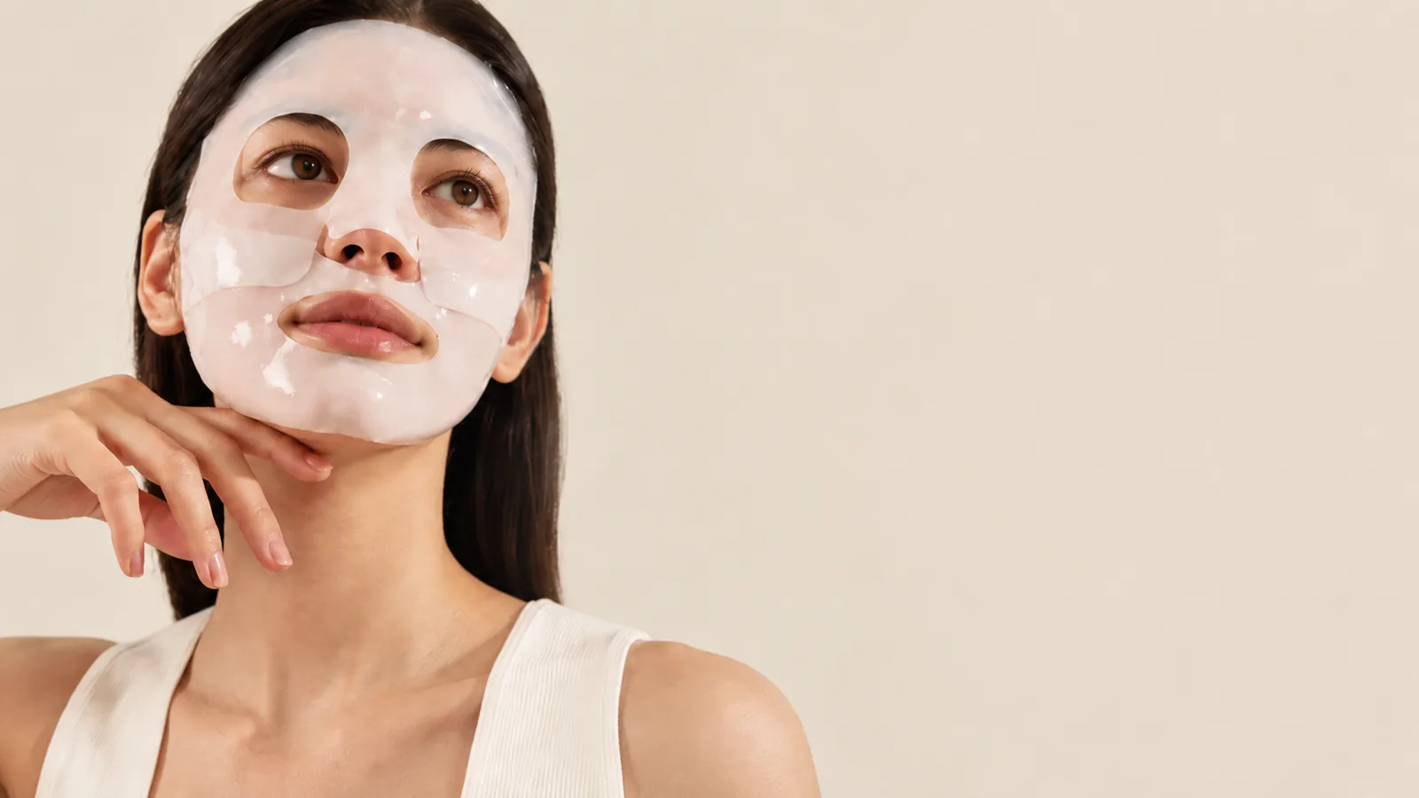 Creator trying a sheet mask on camera