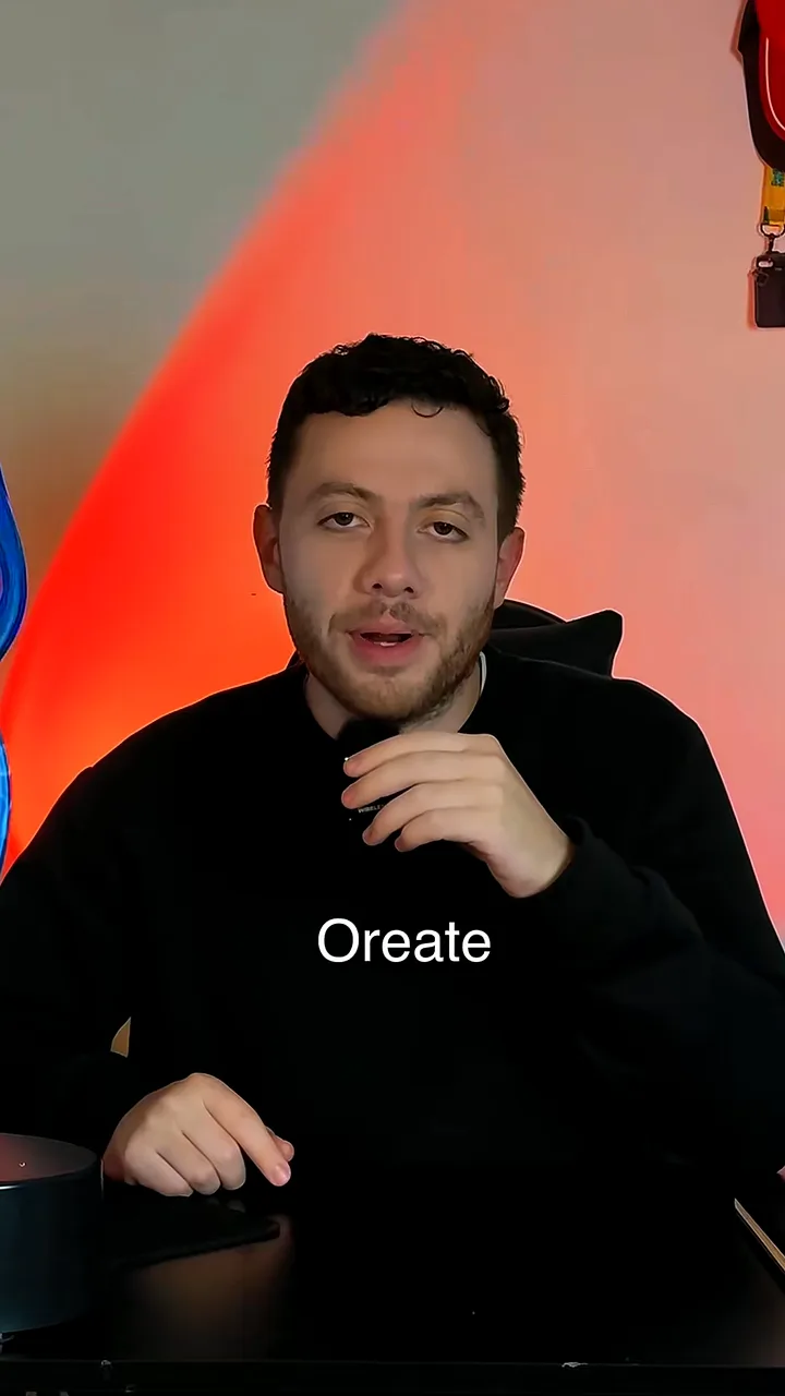 Creator in a black hoodie talking to camera in a studio lit red