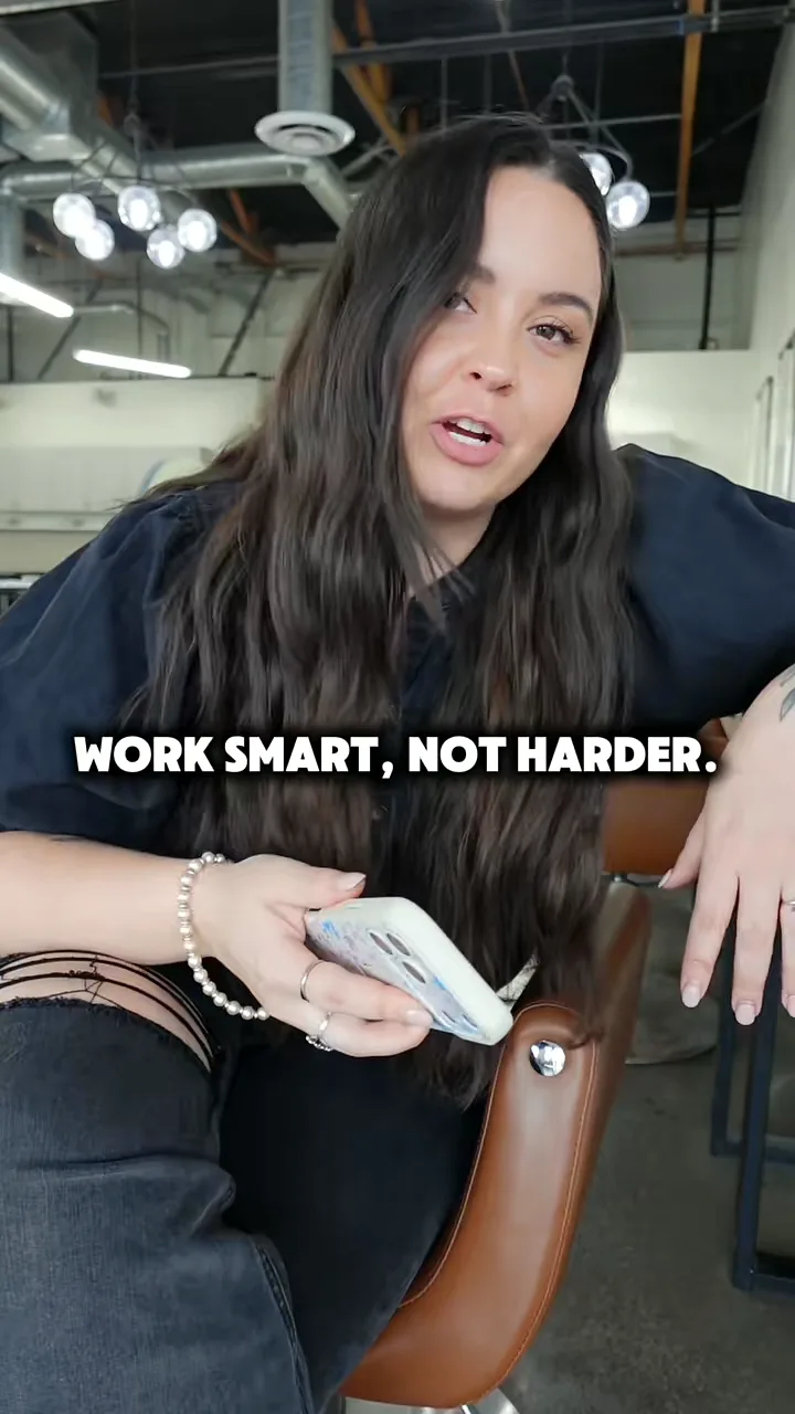 Creator holding a phone and talking to camera in an open studio