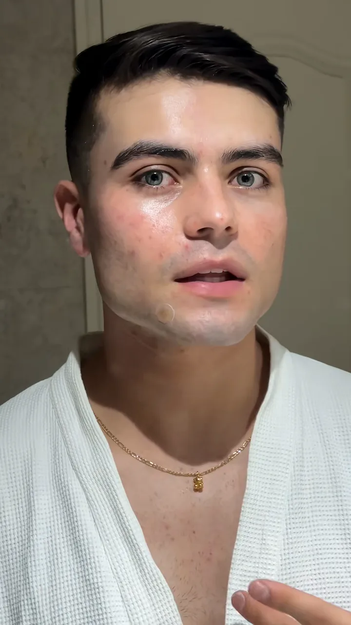 Creator in a white robe talking to camera