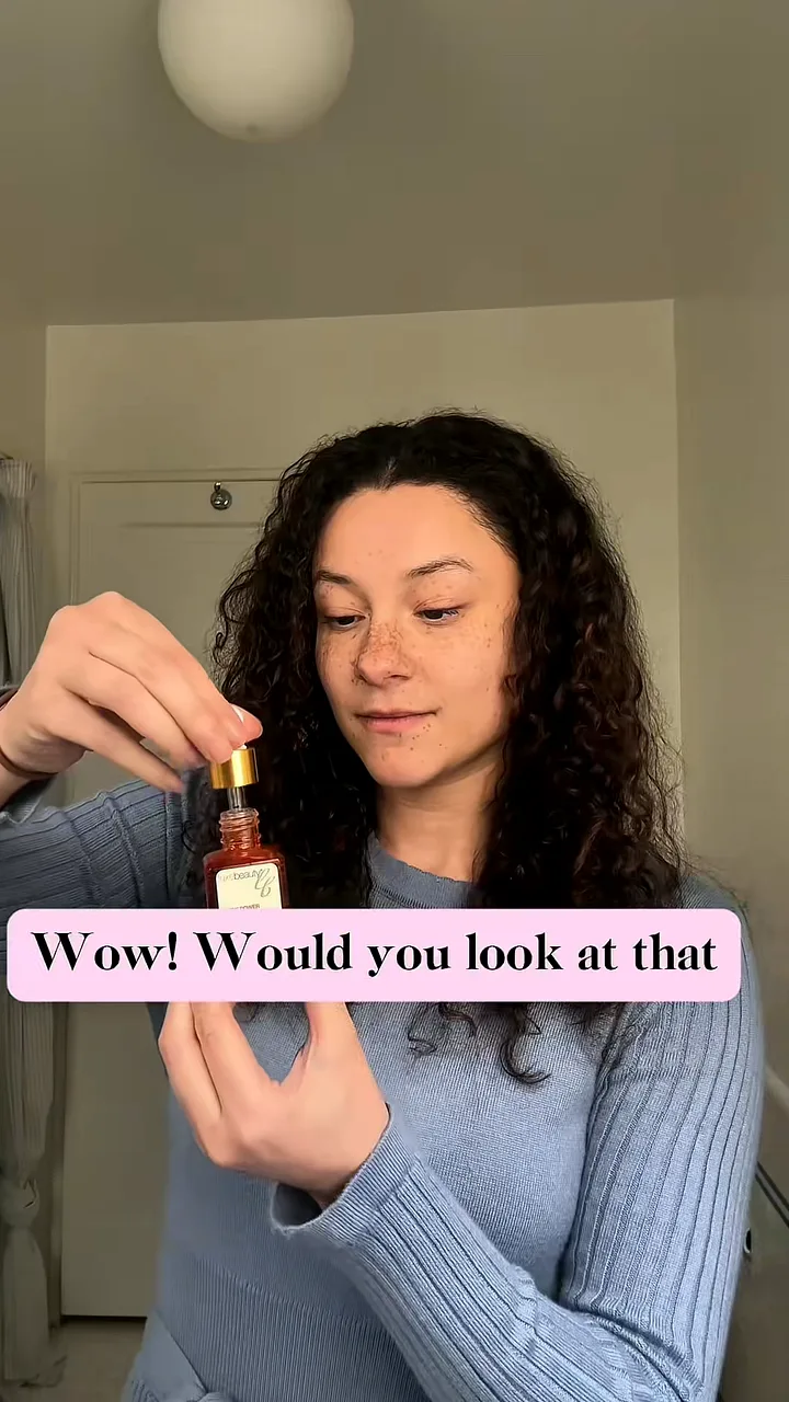 Creator holding a serum bottle and dropper